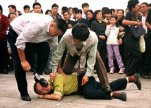 Plainclothes police accost a Falun Gong adherent on Tiananmen Square circa 2000 (?)